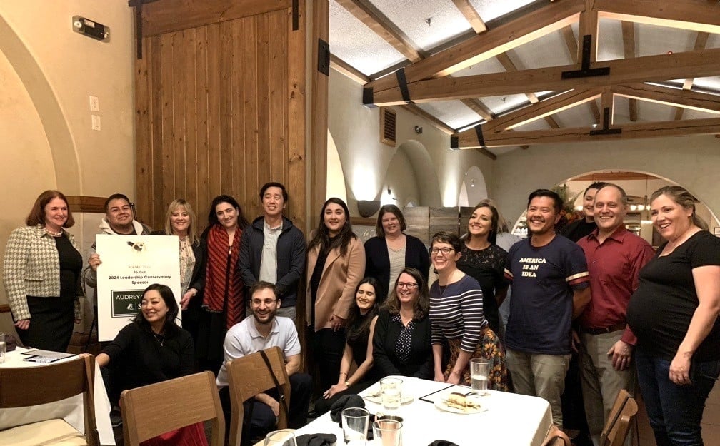 Group of people gathered around a table.